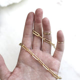 hand holding chunky gold paper clip chain necklace